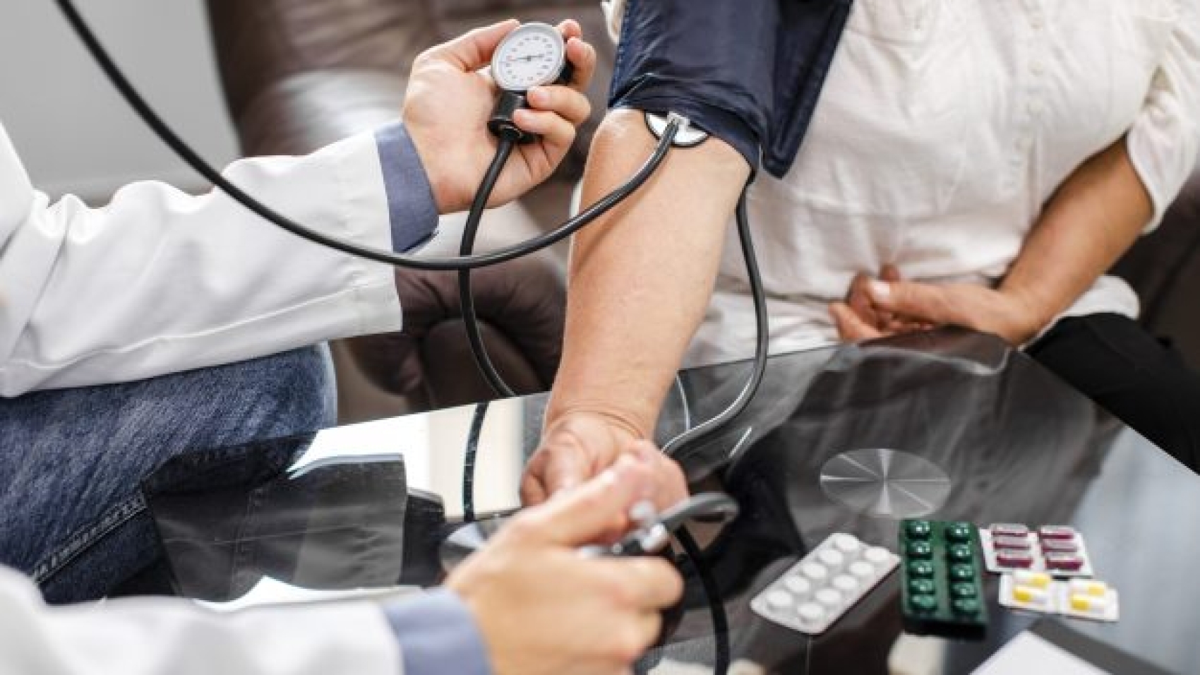 male-doctor-hands-measuring-tension-patient