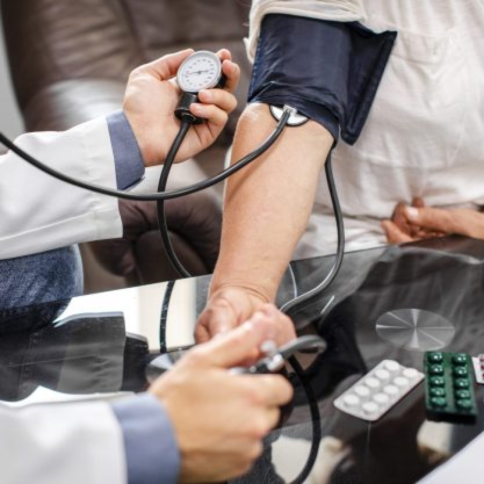 male-doctor-hands-measuring-tension-patient